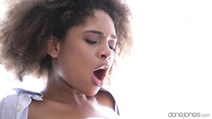 An interracial couple makes passionate love in the kitchen.